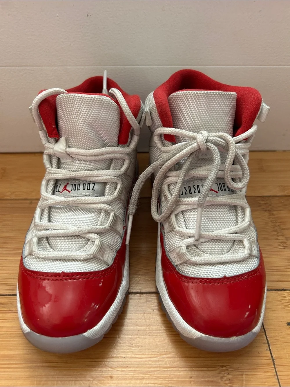 Jordan 11 Retro Kids Sneakers in White, Varsity Red, Black.